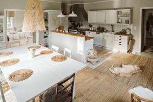 a kitchen with a table and a dog laying on the floor at HALI - Hideaway in Raseborg