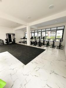 a gym with several treadmills and machines in a room at Cozystays by Vee Near JKIA in Nairobi