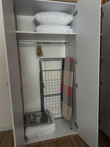 a closet with two pillows and a towel at Kobylianska-Premium 2 Room in Chernivtsi