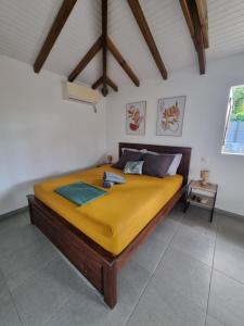 a bedroom with a large bed in a room at Le Cataleya in Sainte-Rose