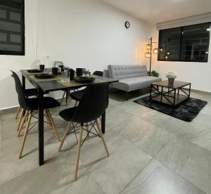 a dining table and chairs in a living room at Habitara - Carancho in Atasta de Serra