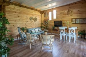 a living room with a couch and a table and chairs at casa Villa Escondida in Cádiz