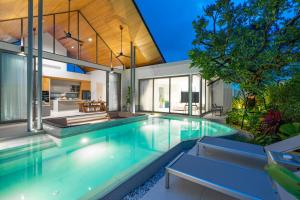 an indoor swimming pool in a house at Botanica Aroon Luxury Pool Villa 3 BR Lagoona Bangtao beach in Ban Pak Lak