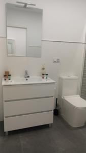 a white bathroom with a sink and a toilet at Bruma in Vilagarcia de Arousa