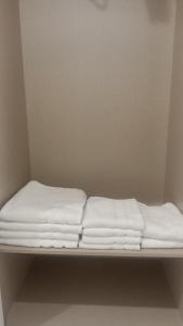 a bed with white sheets sitting on a shelf at Bruma in Vilagarcia de Arousa