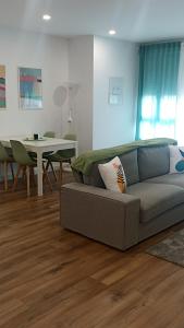 a living room with a couch and a table at Bruma in Vilagarcia de Arousa