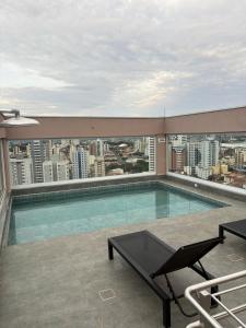 a swimming pool on the roof of a building at Red Building Apartment in Bauru