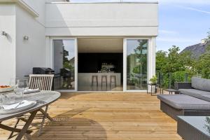 an open patio with a table and a couch at Villa in the Heart of Aarhus in Aarhus