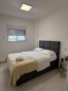 a bedroom with a large bed in a room at Red Building Apartment in Bauru