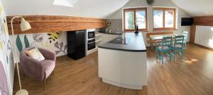 a kitchen and living room with a counter and chairs at Hanselerhof Jaufental Ratschings mit Sauna in Racines