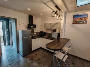 a kitchen with a refrigerator and a table and chairs at Dolce vita in Menton