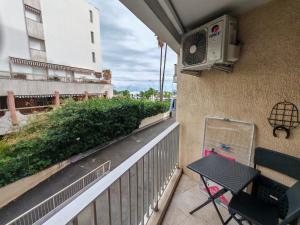 a balcony with a chair and a heater on a building at Dolce vita in Menton
