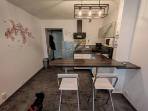 a kitchen with a large wooden table and two stools at Dolce vita in Menton