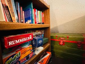 a book shelf filled with lots of books at Family-Friendly Home w Hot Tub Fire Pit Games in North Glade