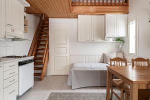 a kitchen with white cabinets and a table and a dining room at Levi Lumia Home, Moonlight 409 in Levi