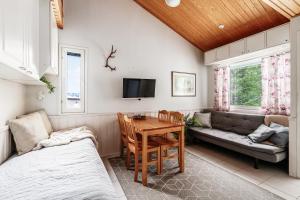 a living room with a couch and a table at Levi Lumia Home, Moonlight 409 in Levi