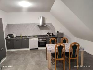 a kitchen with a table with chairs and a stove at Fe-Wo Varenrode in Spelle +12 photos