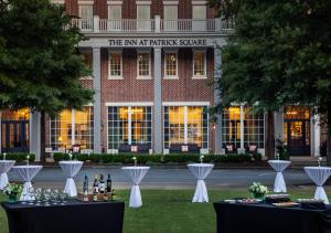 an event in front of a building with tables with wine bottles at The Inn at Patrick Square in Clemson +6 photos