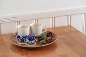 a tray with two cups and christmas decorations on a table at Levi Lumia Home, Moonlight 409 in Levi +7 photos