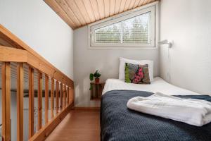 a small bedroom with a bed and a window at Levi Lumia Home, Moonlight 409 in Levi