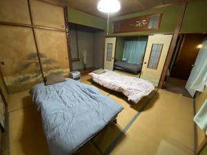 Ένα ή περισσότερα κρεβάτια σε δωμάτιο στο 九州 福岡 貸切 プライベートハウス