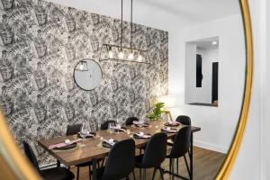 una sala da pranzo con un tavolo e uno specchio di Downtown Penthouse 2 Level-4BDRS-8Guests a Montréal Altre 38 foto