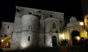 an old stone building at night with lights at Casa Daniele in Gerace