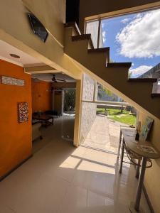 a room with a staircase and a table and a window at Natural Hostel Colon in Colón