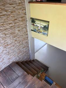 a stairway with a brick wall and a painting on the wall at Natural Hostel Colon in Colón