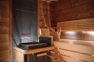 a sauna with a tub in a wooden room at Hotel Gasthaus Schäfle in Bürserberg +94 photos