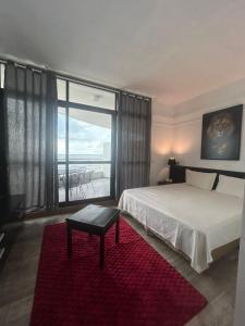 En eller flere senge i et værelse på Tropical VIsão da Ponta Negra