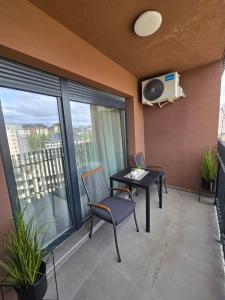 a balcony with a table and chairs in a building at Centar Balkan Square in Zlatibor +22 photos