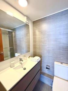 Nuevo departamento en peninsula- cavancha في إكيكي: حمام مع حوض و مرآة و مرحاض