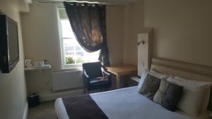 En eller flere senge i et værelse på Beaumond Cross Inn