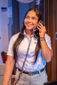 a woman talking on a phone while talking on a cell phone at Neos Hotel Cartagena in Cartagena de Indias