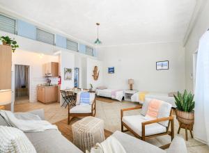 a living room with two beds and a kitchen at Kokomo Culebra in Culebra