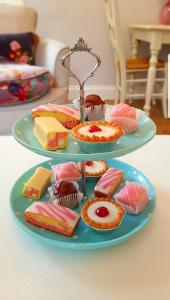 two plates of different types of desserts on a table at Holmlea Cottage in Freuchie