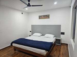 a bedroom with a bed and a ceiling fan at Mystic Resort Dublagadi in Balasore