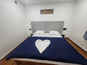 a bed with a heart shaped pillow on it at Mystic Resort Dublagadi in Balasore +1 photo
