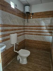 a bathroom with a toilet and a sink at Mystic Resort Dublagadi in Balasore