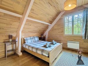 ein Schlafzimmer mit einem Bett und einer Holzwand in der Unterkunft Moulin Vrindavan, Havre de paix en pleine nature à Eysus in Eysus