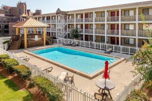 an image of a swimming pool in front of a building at Legends 149 in Tallahassee