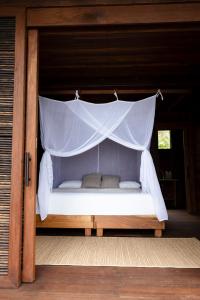 a bed with a canopy in a room at Irana Pacific Hotel in Nuquí +24 photos