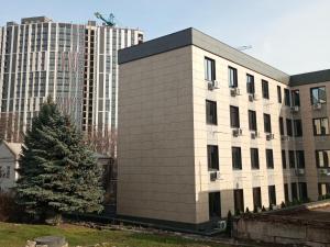 a building with a christmas tree in front of some buildings at АппартОтель,Софія,пл Соборна in Dnipro
