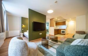 Una sala de estar con un sofá y un televisor en Le Splendide, en Mâcon