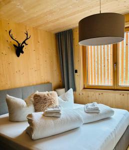 a bedroom with a bed with towels on it at Mellau Apartments in Mellau