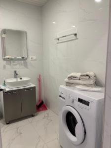 a bathroom with a washing machine and a sink at Alvina Complex s in Tsaghkadzor