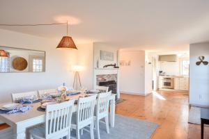 a dining room and living room with a table and chairs at Beautiful Water Views Dogs Welcome in Truro +32 photos