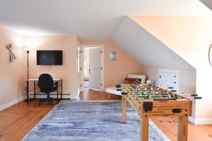 a living room with a foosball table at Beautiful Water Views Dogs Welcome in Truro