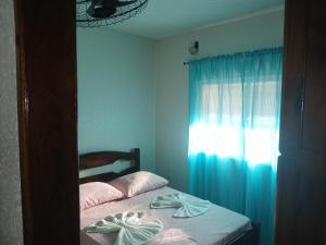 En eller flere senge i et værelse på Casa no Bosque Felizcidade